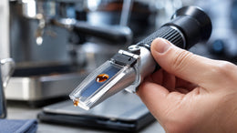 Handheld refractometer measuring liquid concentration in a kitchen or beverage setting