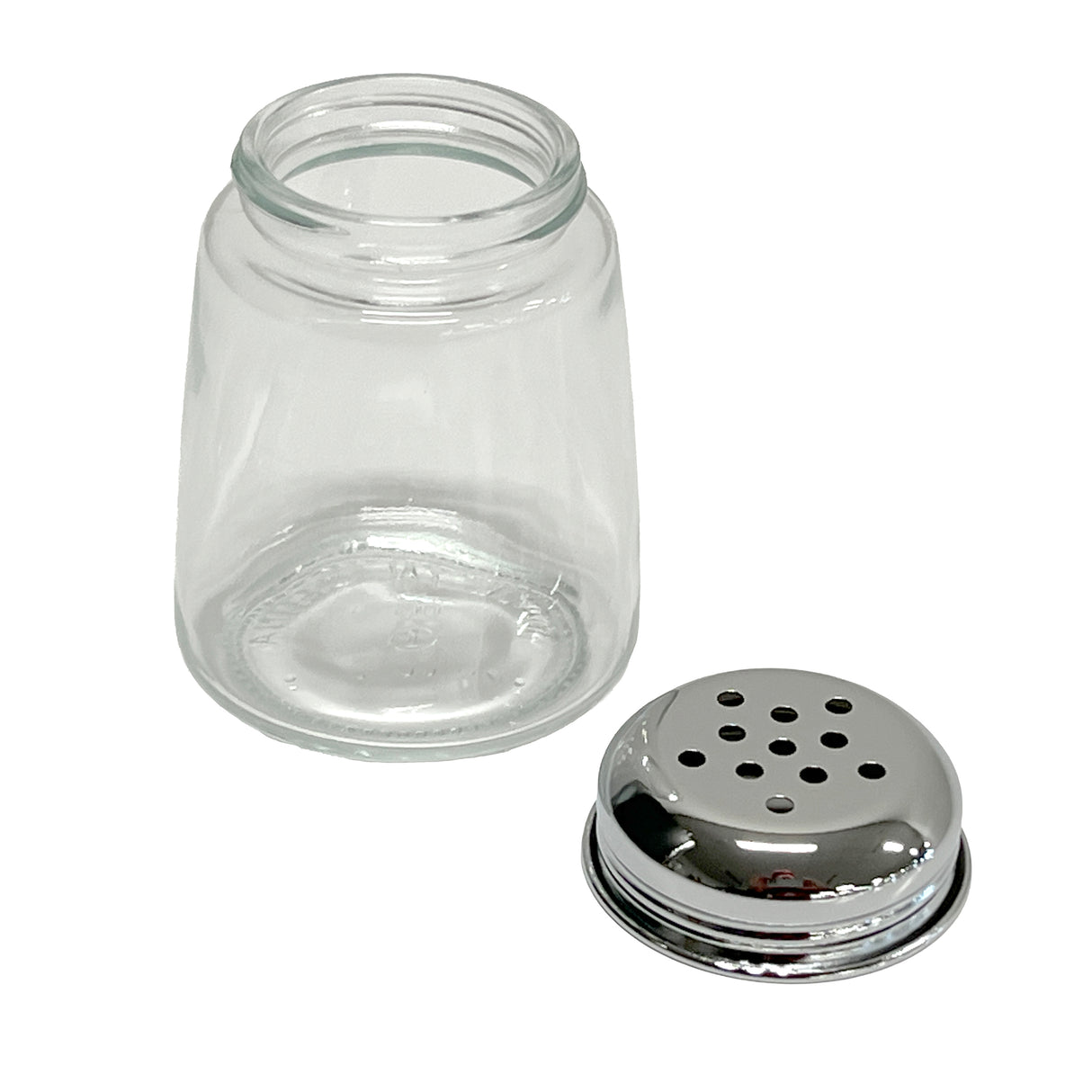 A modern glass cheese shaker jar with a wide opening sits next to its detached metal lid, which has multiple round holes for dispensing. Both the jar and dishwasher safe lid rest on a clean white background.
