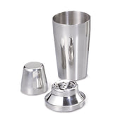 A three-piece 16 oz stainless steel bar shaker set with the cup upright, the fitted strainer in front, and the small cap on its side, all reflecting light on a white background.