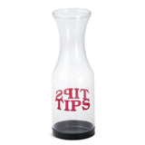 A clear, empty Tip Carafe with a black base sits upright. The word TIPS is printed in bold red letters on the front and mirrored above it for double-sided readability. Made in USA and dishwasher safe for easy cleaning.