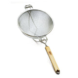 A double medium mesh strainer with a round basket and a flat wooden handle, photographed on a white background. The handle features a metal loop, and a support hook opposite the handle allows it to rest on a pot or bowl.
