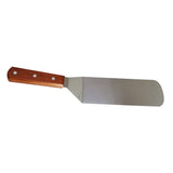 A Food Turner featuring a wide, rectangular stainless steel blade and a wood handle secured by three silver rivets. The blade has one rounded corner and one angled side near the handle, shown against a white background.