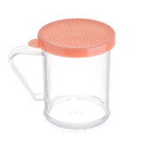 A clear, cylindrical BPA free plastic dredge shaker with a transparent handle and a peach-colored, perforated lid designed for sifting medium ground spices. The empty container sits on a white background.