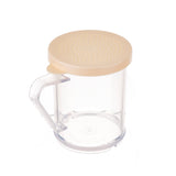 A clear plastic container with a beige universal, dishwasher safe perforated lid and transparent handle, perfect for sprinkling flour or powdered sugar. The empty container is shown on a white background, ideal as a replacement dredge lid solution.
