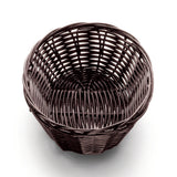 A round, empty, dark brown hand-woven basket sits on a white surface. The tightly woven pattern of polypropylene cord features visible vertical and horizontal strands, creating an open, airy texture. The view from above shows the circular shape inside.