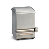A small, rectangular stainless steel toothpick dispenser with a matte finish and slightly curved lid. It features a side knob and a horizontal slot at the front, both metallic-textured, and stands on four small feet against a white background.