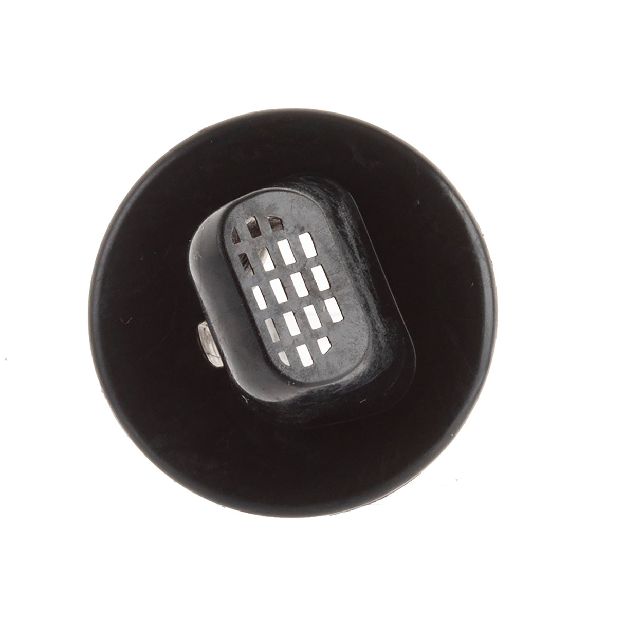 A black round object with a raised rectangular vent in the center, featuring a grid of rectangular holes. Photographed from above, it resembles a TableCraft Free Flow Pourer with its flat circular base and central grated section against a white background.