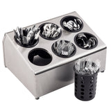 A stainless steel flatware cylinder utensil holder with six round black polypropylene compartments neatly organizing spoons, forks, and knives—one marked TableCraft fork compartment is placed outside the holder in the foreground against a white background.