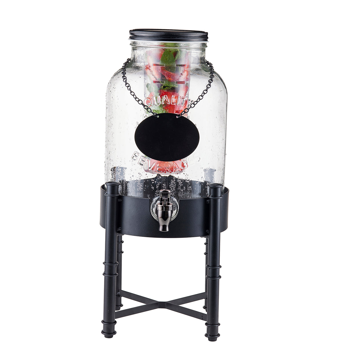 A clear glass TableCraft Industrial Collection metal beverage dispenser with a black spigot stands on a tall black beverage dispenser base. Inside, fruit and herbs float, while a blank round label hangs from a chain beneath the black lid.