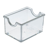 A clear acrylic Sugar Packet Holder by TableCraft, featuring an open top, curved cutouts on each side, four rounded corners, and raised feet. Its smooth surface is dishwasher safe for easy cleaning and long-lasting use.