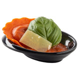 A TableCraft 10314BK mini melamine bowl holds a single orange ravioli in red sauce, topped with basil and Parmesan, all set against a white background. Durable and dishwasher safe for easy cleanup.