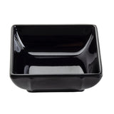 A glossy, empty black square bowl is shown against a white background. The bowl has smooth, slightly rounded edges and a deep interior, with light reflecting off its shiny surface. This stylish piece is also dishwasher safe for easy cleaning.