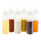 Six clear WideMouth Squeeze Bottles made of polyethylene with white caps are lined up, each filled with a different colorful condiment. The bottles, set against a white background, are dishwasher safe for easy cleaning.
