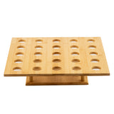 A rectangular, light-colored bamboo cone holder with 24 evenly spaced circular holes in four rows of six. Supported by a sturdy central base, this TableCraft Products cone holder is ideal for holding or displaying assorted items.