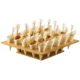 A TableCraft natural bamboo cone holder tray holds 24 small cones arranged in rows, each filled with breaded or doughy bite-sized appetizers. Looped skewers add a decorative touch, while holes keep the cones securely upright.