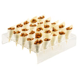 A clear TableCraft cone holder displays 24 small, cream-colored paper cones filled with chopped brown treats, possibly caramelized nuts or granola. The cones are neatly arranged in rows, pointed downward into holes in the acrylic stand.