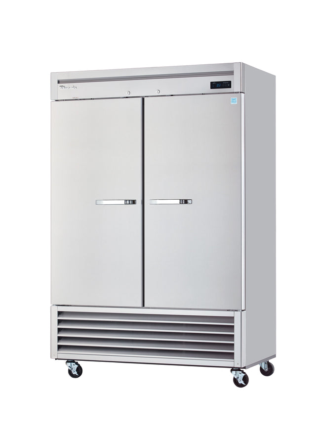 A large, stainless steel reach-in refrigerator stands on four casters. This commercial two-section refrigerator features sleek handles, a digital display at the top right, bottom vents, and an industrial design set against a plain white background.
