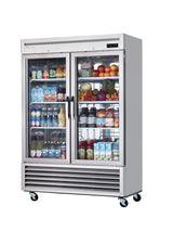 A silver, two-section glass door refrigerator on wheels, stocked with bottled drinks, canned beverages, and water on the left side, while fresh fruits and vegetables fill the right—perfectly organized against a white background.