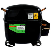 A black Secop compressor, used in Empura Ice Machines like the E-MCF430, features copper pipe fittings, green and yellow labels for model SCE15MNX and refrigerant R290, mounting feet at its base, and an electrical terminal cover on the right side.