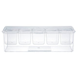 A clear polystyrene condiment holder with four compartments and a hinged lid, shown from the front. This TableCraft Products bar condiment holder is empty and transparent, revealing the separate sections inside.
