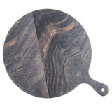 A round, dark wood serving paddle with natural, wavy grain patterns and a handle on one side with a hole for hanging. The wood tones vary from deep brown to gray, creating a striped and marbled barnwood pattern across the surface.
