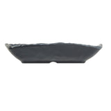A black, ceramic, shallow serving tray with a slightly wavy rim is viewed from the side against a white background. The dish features a modern, minimalist design and an irregular edge, giving it a handcrafted appearance.
