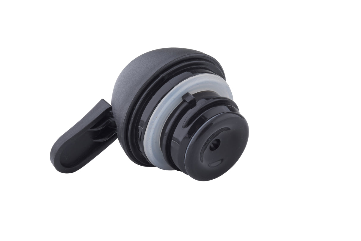 A close-up of a black and gray polypropylene Replacement Lid with a flip-top, photographed on a white background. The cap, compatible with TableCraft bottles, features a circular seal and a small opening for pouring or drinking.