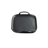 A square, black faux cast iron tray with a short handle on top and a small pouring lip at the bottom, set against a plain white background. The melamine tray features slightly rounded edges and a textured surface.
