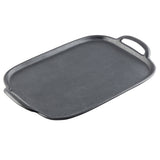 A rectangular, black TableCraft tray with slightly raised edges and two handles on opposite sides. The smooth, sturdy surface resembles cast iron, making it ideal for stovetop or oven cooking. The background is plain white.