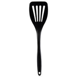 A black, plastic slotted spatula with a long silicone handle and three rectangular slots in the flat, wide blade. The handle has a small hole at the end for hanging. The spatula is positioned vertically on a white background.