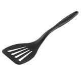 A black plastic slotted spatula with a long silicone handle and four horizontal slots in the flat, wide blade. The handle has a small hole at the end for hanging. The spatula is photographed on a white background.