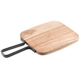 A rectangular acacia serving paddle with rounded edges is shown. It features a smooth surface and a metal handle attached to one side, forming a loop for easy carrying or hanging. The light brown finish highlights the natural wood grain.