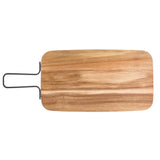 A rectangular wooden cutting board with rounded corners and a natural wood grain pattern, this TableCraft serving paddle features a black metal handle on the left side. The board is shown against a white background.