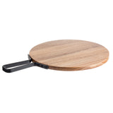 A round acacia serving paddle from the Industrial Collection by TableCraft Products features a natural grain and a rectangular black metal handle, attached with two visible screws, shown against a white background.