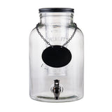 A large, clear glass beverage dispenser from the Industrial Collection features a black spigot and metal lid. The words "Quality Beverages" are embossed on the 2 gallon beverage dispenser, with a blank oval sign hanging from the neck.