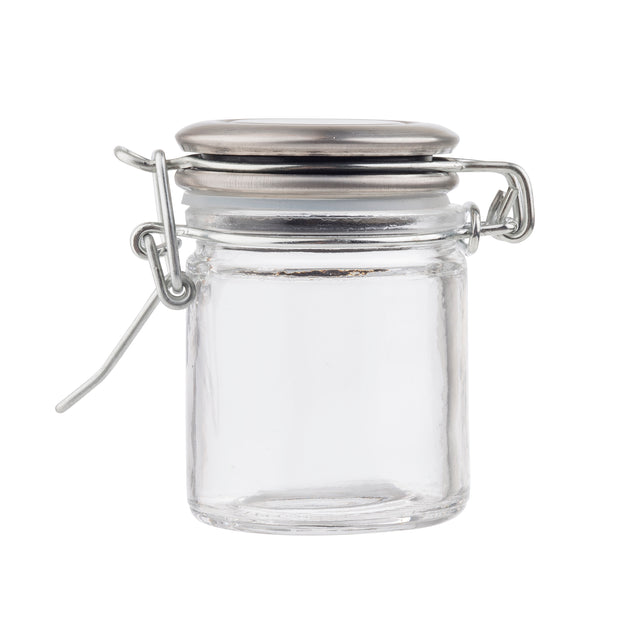 A small, empty clear glass spice jar with a resealable stainless steel clamp lid is shown against a plain white background. The cylindrical jar features smooth sides, a round base, and a secure hinged latch with wire clasp.