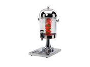 A clear 2 gallon beverage dispenser with a shiny silver lid and base stands on a metal tray. Inside, water with ice, red fruit slices, and green herbs fills the infusion chamber. A black spigot is attached for easy pouring. The background is plain white.