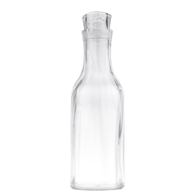 A clear, empty glass carafe with a wide base, narrow neck, and fitted glass stopper. The 1-1/2 qt cylindrical bottle curves outward at the shoulders and stands upright against a plain white background.