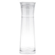 A tall, clear glass carafe with a slightly flared rim and narrow neck sits against a plain white background. Featuring a simple, minimalist design, this carafe comes with a strainer for easy gravity flow pouring.