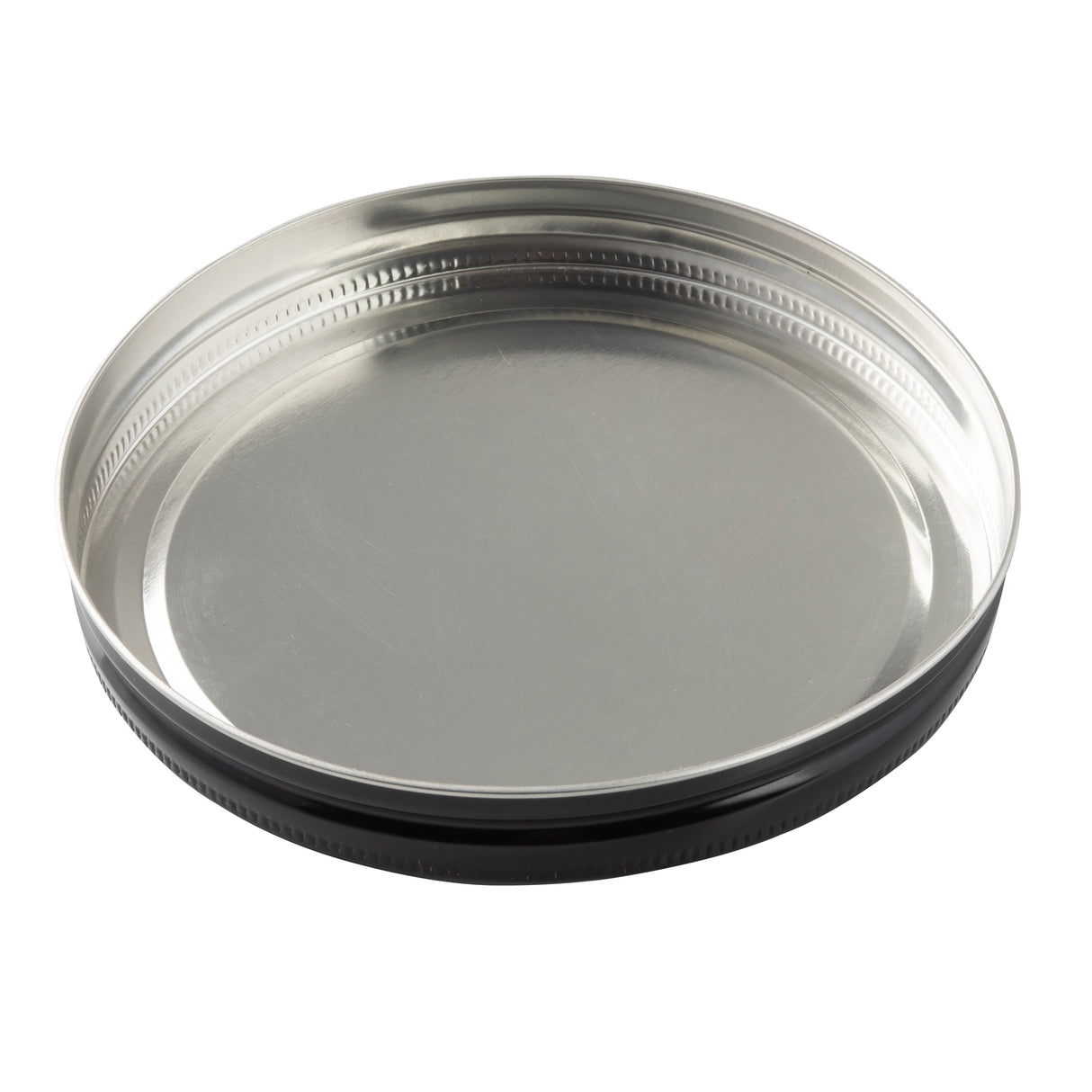 A round, shallow, metallic tin replacement lid with a shiny silver surface, ridged edges, and a black outer rim—designed for a TableCraft beverage dispenser—lies flat with the inner side facing up on a plain white background.