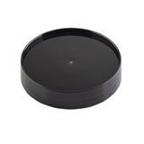 A black, round, plastic Replacement Cap with a slightly raised edge and glossy finish, photographed on a white background. This TableCraft pour lid is plain and smooth, featuring a small circular indentation in the center.