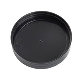 A black, round plastic PourMaster 8032BKBK Replacement Cap with ridged sides and a small central bump, displaying recycling symbols and the text MADE IN CHINA embossed on its surface. The background is plain white.