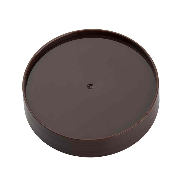 A round, flat, dark brown plastic replacement cap with a raised edge and a small central bump. Designed for sealing a container or jar, this lid from the PourMaster series is dishwasher safe. The background is plain white.