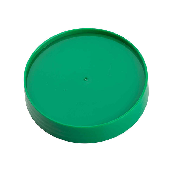 A round, solid green plastic lid viewed from an angle. This replacement cap for a green PourMaster has smooth, slightly raised edges and a flat top surface with a small central mark. Simple, unmarked, and dishwasher safe, it likely fits a cylindrical container.