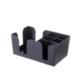 A black ABS plastic Bar Caddy organizer with multiple compartments, including four small square slots and two larger open sections. Its simple, modern design is dishwasher safe and set against a plain white background.