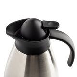A vacuum insulated stainless steel Coffee Carafe with a black plastic handle and spout. The dome-shaped lid features a built-in lever for easy pouring. Its modern, sleek appearance stands out against the plain white background.