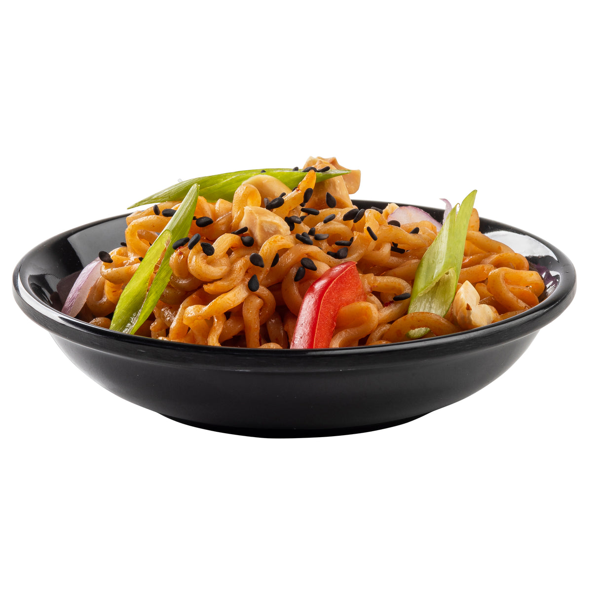 A black mini plate filled with curly noodles, sliced green onions, red bell peppers, and black sesame seeds is isolated on a white background. The colorful vegetables and seeds contrast beautifully with the orange noodles.