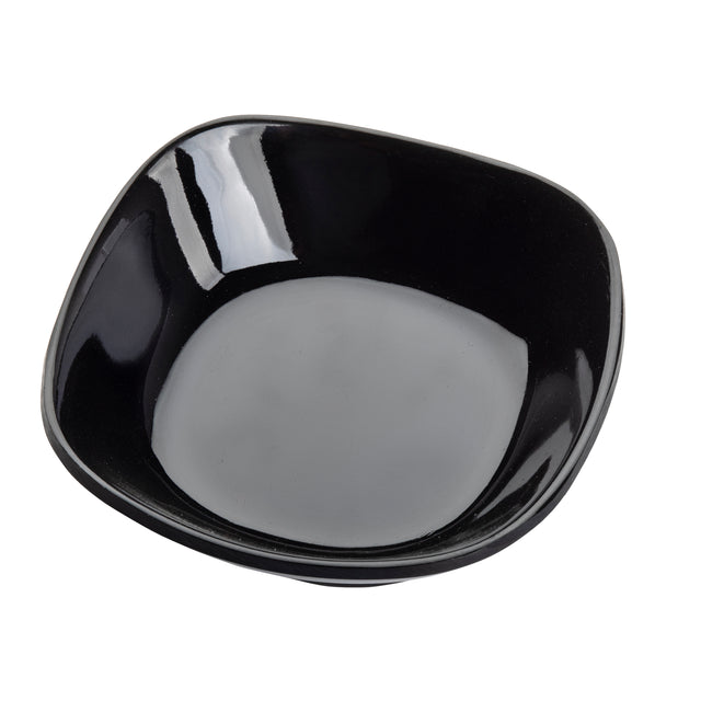 A glossy, empty TableCraft 10315BK black ceramic bowl with rounded square edges is shown against a white background. Its reflective surface creates white highlights on the inner rim. The perspective is slightly above and angled. Dishwasher safe for easy cleaning.