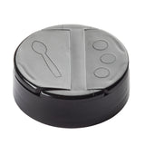 A black plastic replacement shaker top, like the TableCraft 10325, features a perforated flip top lid with two symbols—a spoon and three circles—that indicate its versatile pouring or scooping flaps for easy food service.