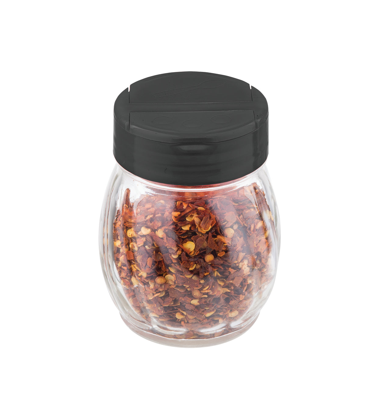A clear glass shaker filled with crushed red pepper flakes, topped with a round black flip top plastic lid, is shown against a plain white background. The pepper flakes are visible through the transparent jar.